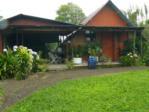 A rental cabina with a roofed outdoor activity area is 50 yards from the main house.